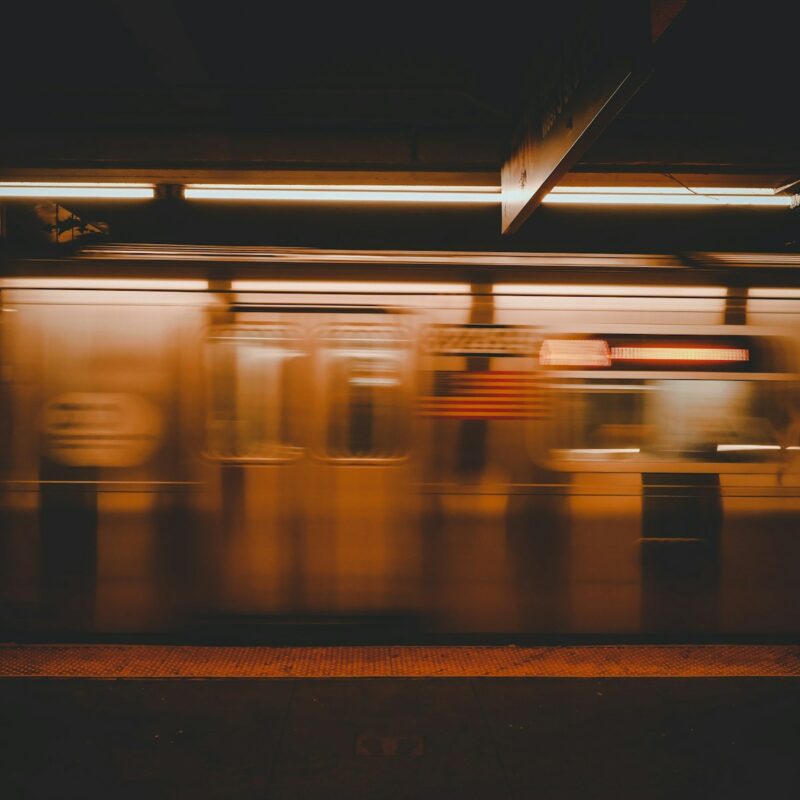 a blurry photo of a subway train at night