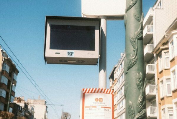 a street sign with a tv mounted to it's side