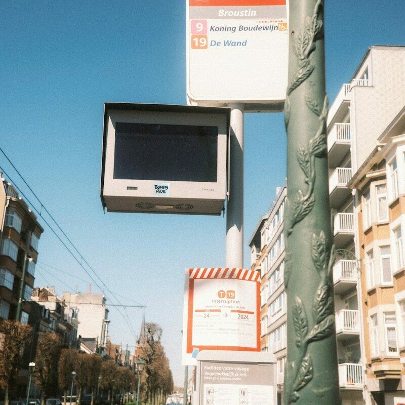 a street sign with a tv mounted to it's side